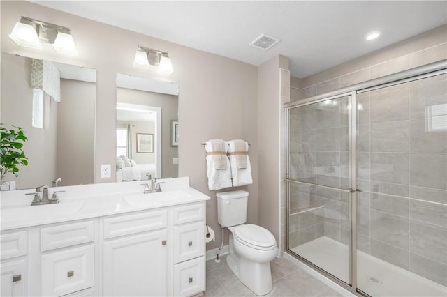 bathroom featuring vanity, toilet, walk in shower, and tile patterned flooring