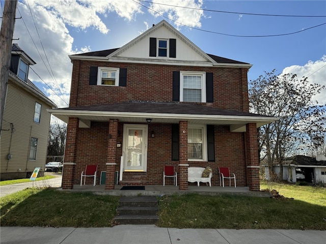 view of front of house with a front yard and a porch