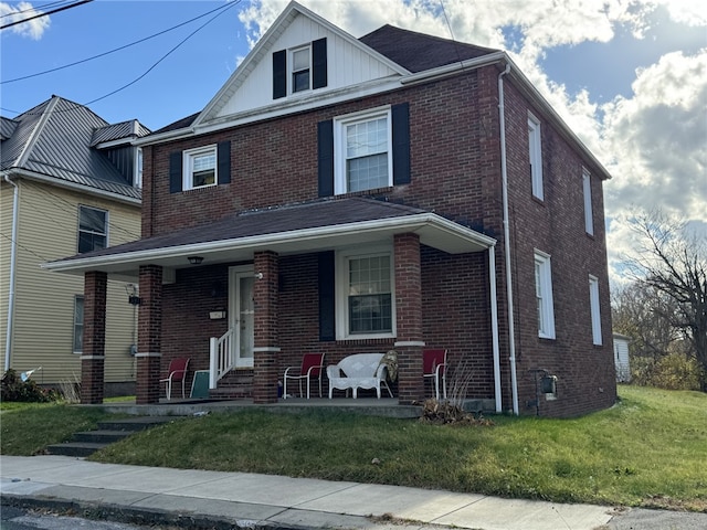 view of front facade with covered porch and a front lawn