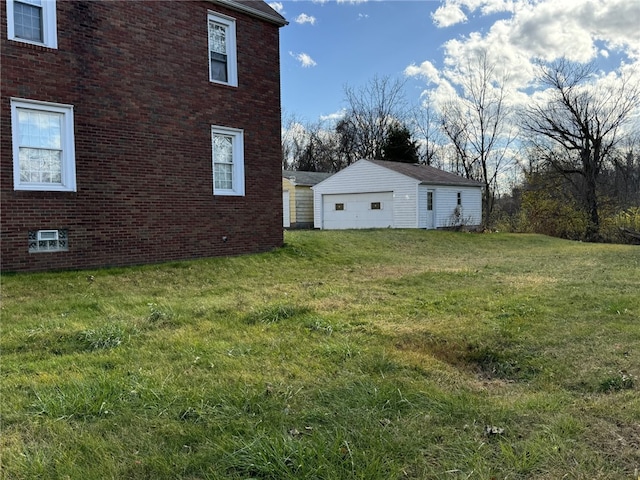 view of home's exterior with a yard, an outbuilding, and a garage