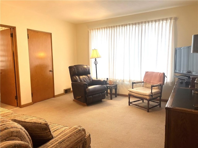 sitting room with light colored carpet