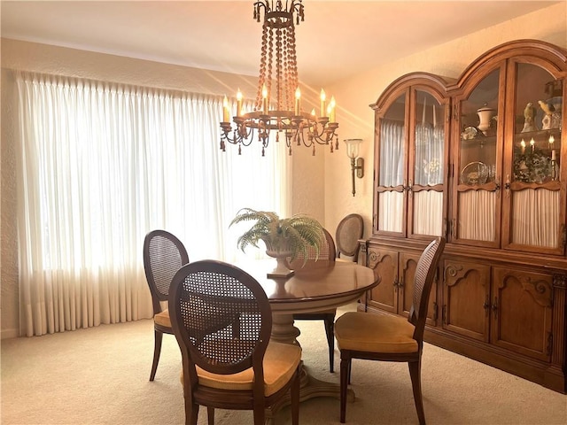 carpeted dining space featuring a chandelier