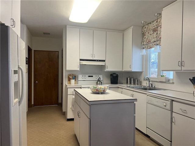 kitchen featuring white appliances, white cabinetry, sink, and a kitchen island