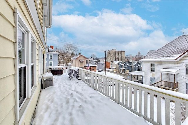 snow covered back of property featuring a grill