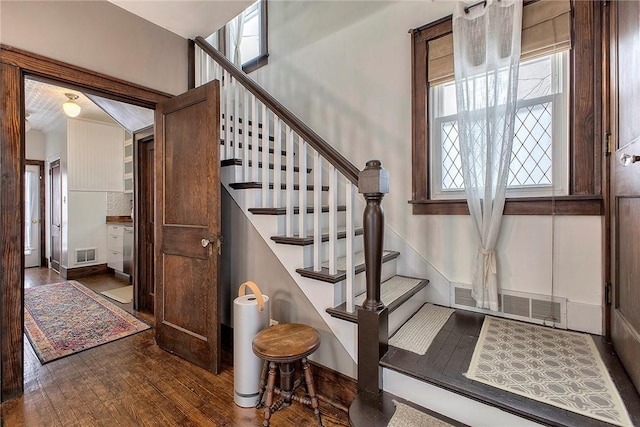 stairs with hardwood / wood-style floors