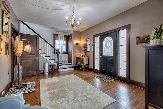 entryway with a chandelier and dark hardwood / wood-style floors