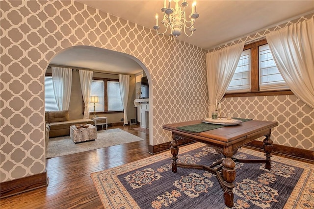 interior space featuring hardwood / wood-style flooring, a chandelier, and plenty of natural light