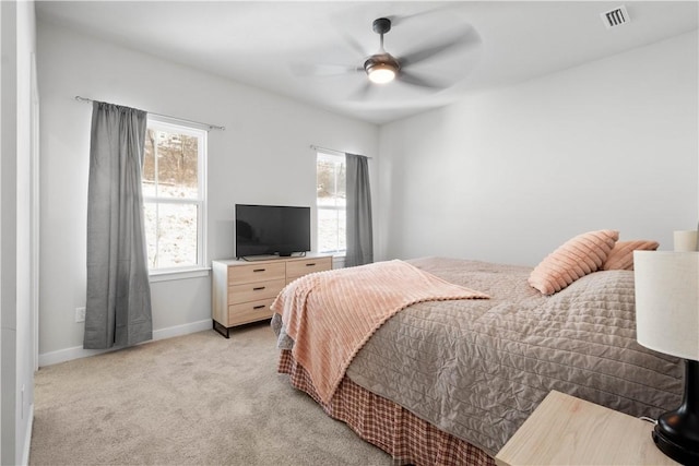 bedroom with ceiling fan and light colored carpet