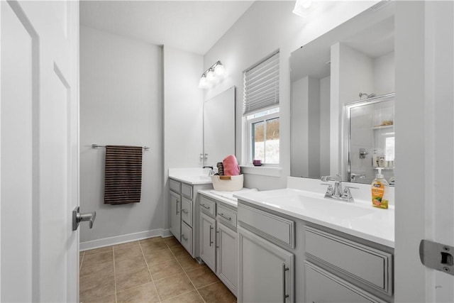 bathroom featuring tile patterned floors, a shower with shower door, and vanity