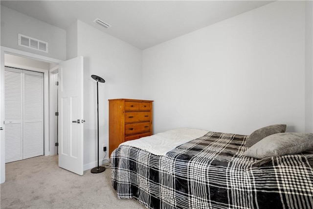 bedroom featuring light colored carpet and a closet