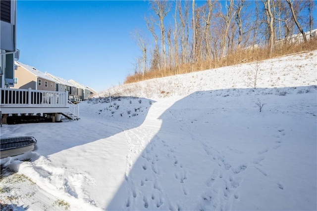 yard covered in snow featuring a wooden deck