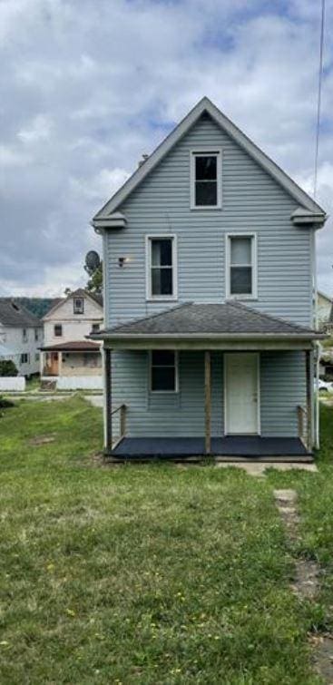 rear view of house with a yard