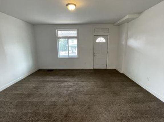 view of carpeted foyer entrance