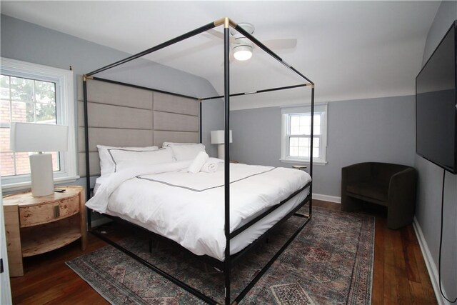 bedroom with ceiling fan and dark wood-type flooring