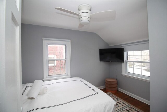 bedroom with hardwood / wood-style flooring, ceiling fan, and vaulted ceiling