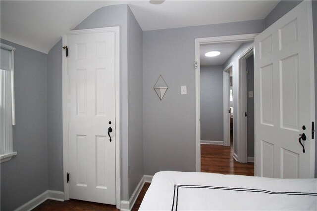 bedroom featuring lofted ceiling and dark hardwood / wood-style flooring