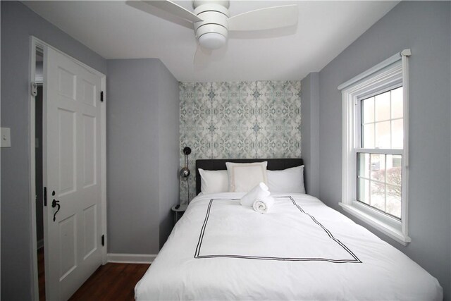 bedroom featuring dark wood-type flooring and ceiling fan