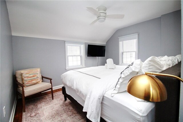 bedroom featuring vaulted ceiling, dark wood-type flooring, and ceiling fan