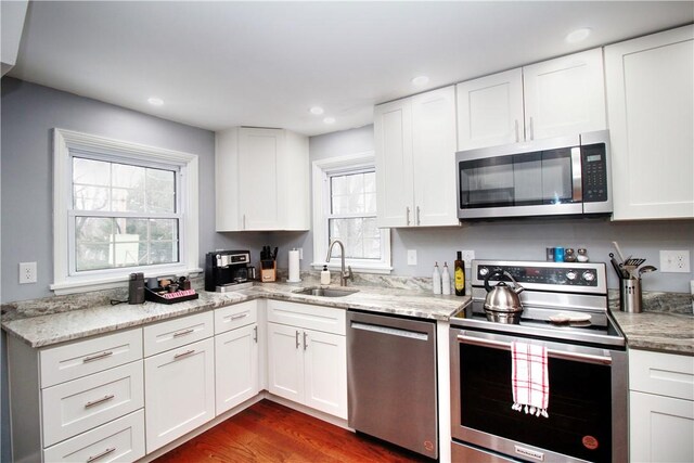 kitchen featuring sink, appliances with stainless steel finishes, and white cabinetry