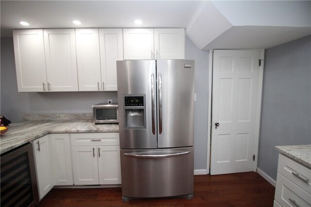 kitchen featuring white cabinets, stainless steel fridge with ice dispenser, and wine cooler