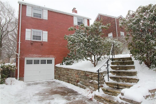 snow covered building with a garage