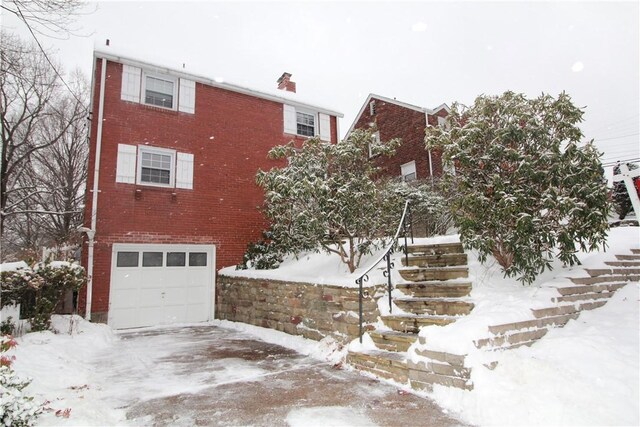 snow covered building with a garage