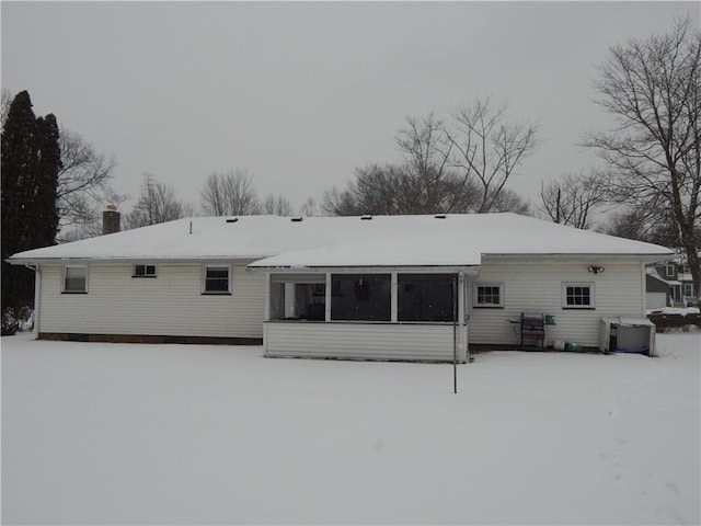 view of snow covered back of property