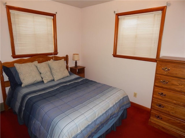 bedroom featuring dark carpet