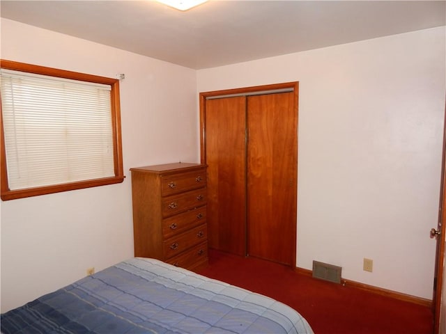 carpeted bedroom featuring a closet