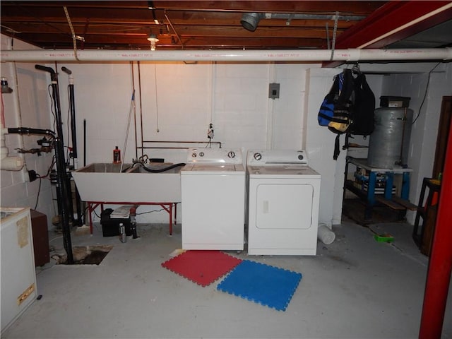 basement with separate washer and dryer and sink