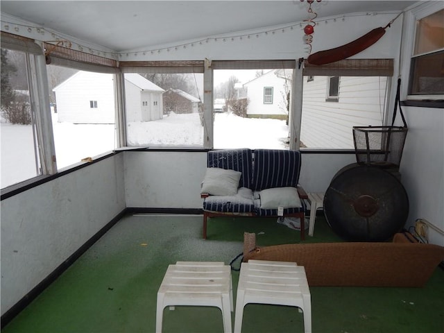 unfurnished sunroom featuring lofted ceiling