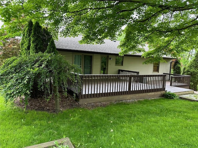 back of house featuring a deck and a yard