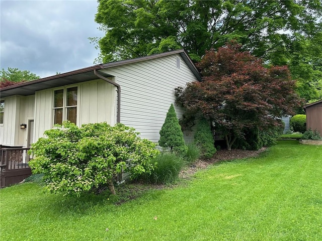 view of side of home with a lawn