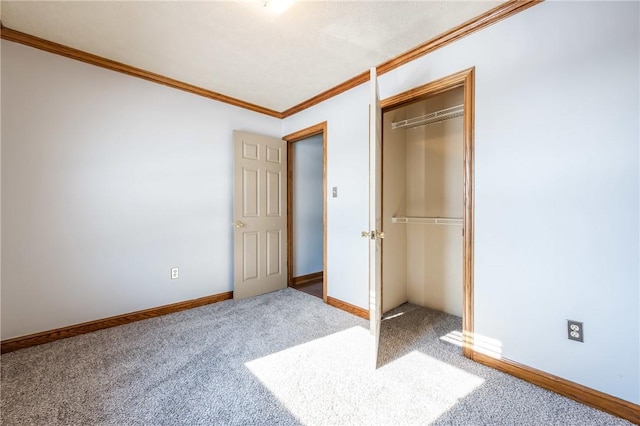 unfurnished bedroom with carpet floors, a closet, and crown molding