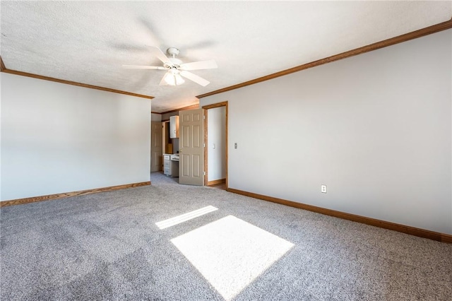 carpeted spare room featuring a textured ceiling, ceiling fan, and ornamental molding