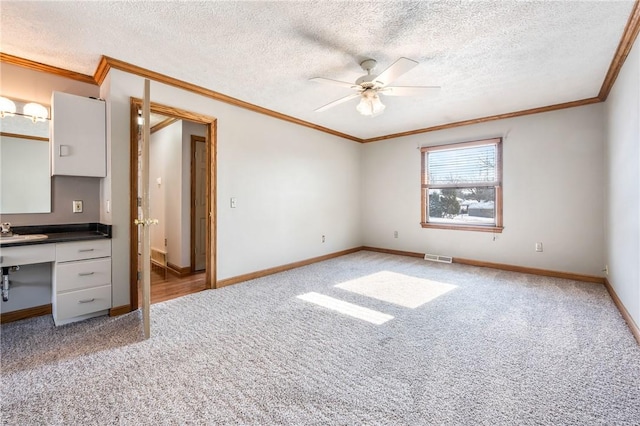 unfurnished bedroom featuring light carpet, ceiling fan, and crown molding