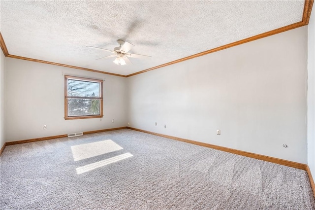 carpeted spare room with ceiling fan, crown molding, and a textured ceiling