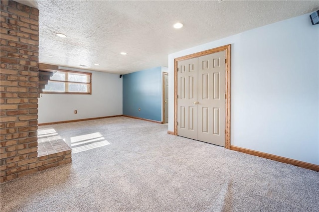 carpeted spare room with a textured ceiling