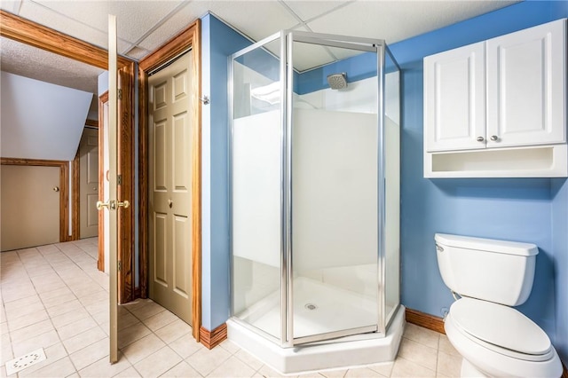 bathroom featuring an enclosed shower, tile patterned floors, and toilet