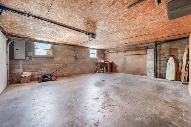 garage with a garage door opener and electric panel