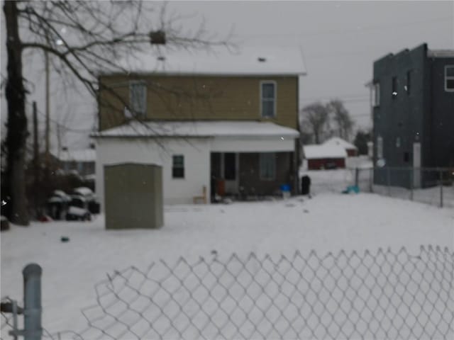 view of snow covered back of property