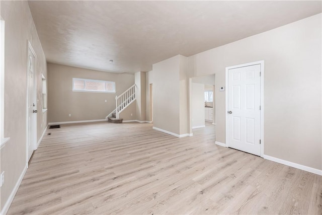 unfurnished room with light wood-type flooring