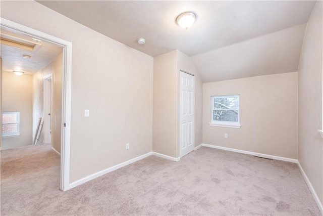 additional living space with lofted ceiling and light carpet