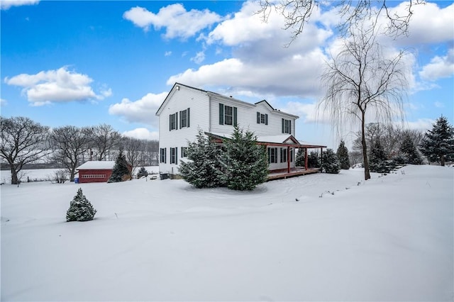 snow covered property with a porch