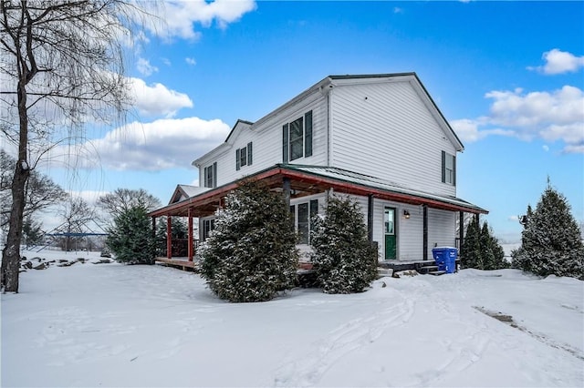 view of snow covered exterior with covered porch