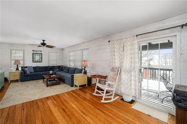 living room featuring ceiling fan and hardwood / wood-style floors