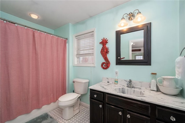 full bathroom featuring toilet, vanity, and shower / tub combo with curtain