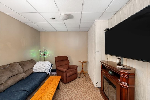 living room featuring a drop ceiling