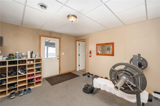 workout area with carpet and a drop ceiling