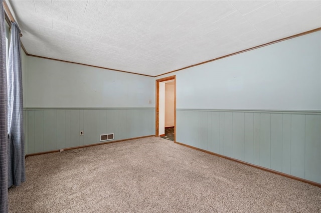 carpeted spare room featuring ornamental molding